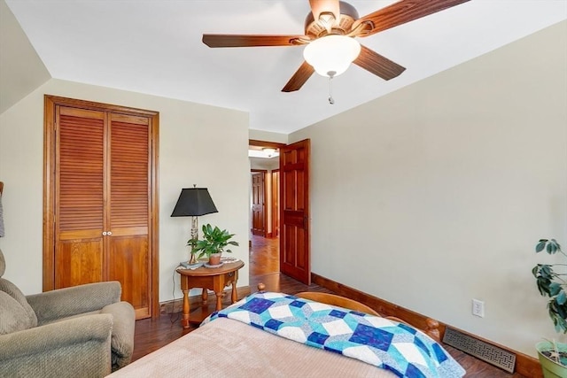 bedroom with lofted ceiling, ceiling fan, a closet, and dark hardwood / wood-style floors