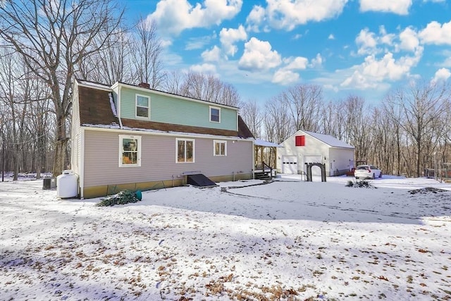 view of snow covered back of property