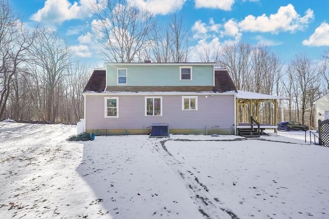 snow covered property featuring cooling unit