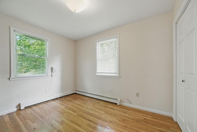 20 Tarleton Rd, Boston, MA 02132 - unfurnished bedroom with a closet, light wood-style floors, a baseboard heating unit, and baseboards