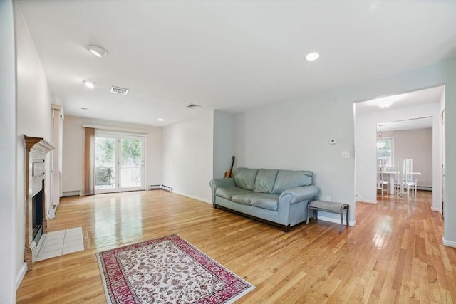 20 Tarleton Rd, Boston, MA 02132 - living room featuring light wood finished floors, baseboard heating, a fireplace with flush hearth, and baseboards