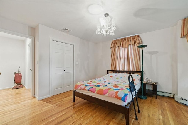 20 Tarleton Rd, Boston, MA 02132 - bedroom featuring light wood-style floors, a chandelier, baseboards, a closet, and baseboard heating