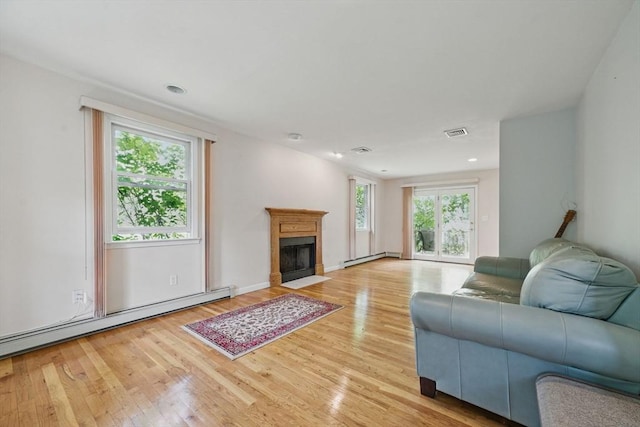 20 Tarleton Rd, Boston, MA 02132 - living room featuring a baseboard radiator, light wood-style floors, a fireplace with flush hearth, and recessed lighting