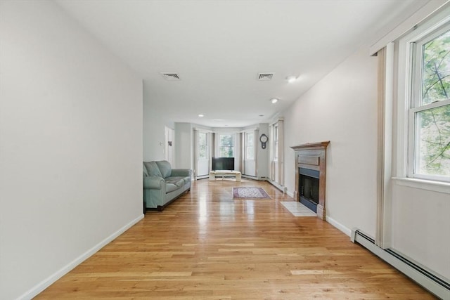20 Tarleton Rd, Boston, MA 02132 - unfurnished living room with baseboard heating, plenty of natural light, a fireplace with flush hearth, light wood-type flooring, and recessed lighting