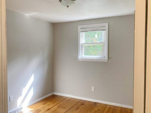 spare room with light hardwood / wood-style flooring