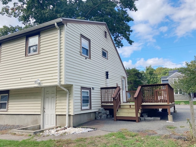 rear view of house featuring a deck