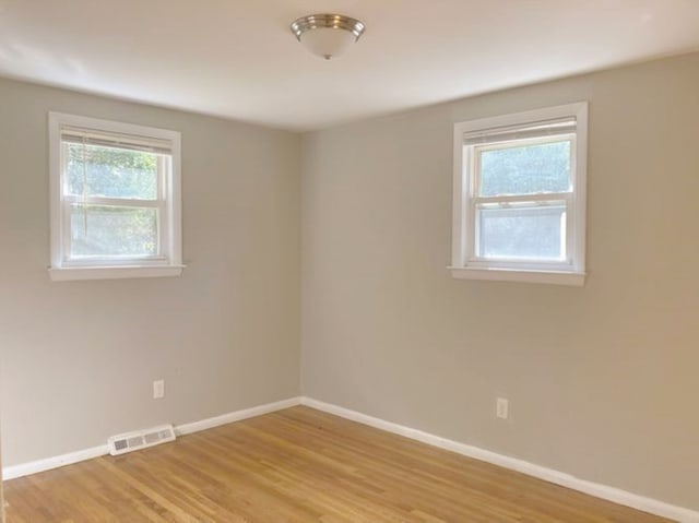 unfurnished room with light hardwood / wood-style flooring and plenty of natural light