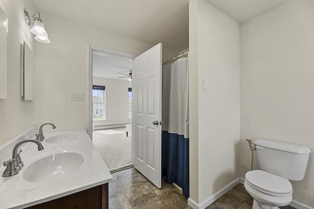 bathroom with baseboard heating, baseboards, toilet, and a ceiling fan