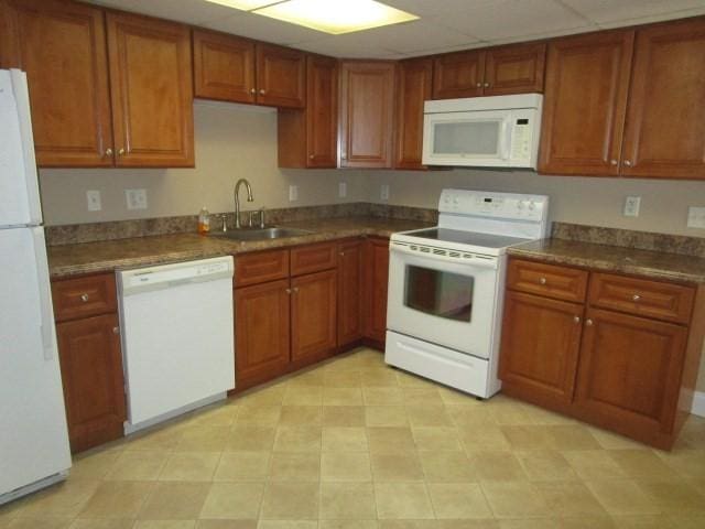 kitchen featuring white appliances and sink