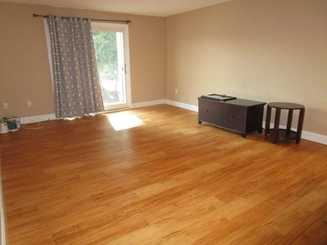 unfurnished room with hardwood / wood-style flooring