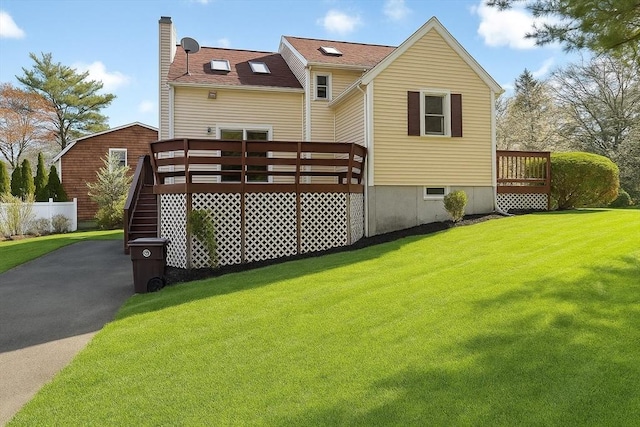52 Wainwright Ave, Weymouth, MA 02190 - rear view of property featuring a lawn, a wooden deck, and a chimney