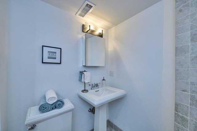 half bath featuring toilet and visible vents