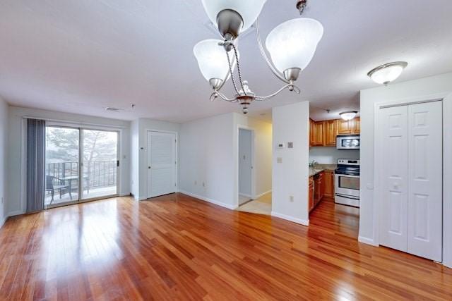 interior space with a chandelier and light hardwood / wood-style flooring