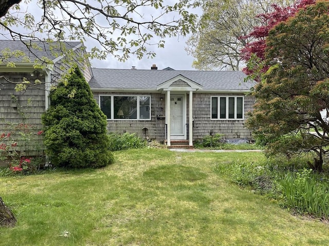 57 Harrington St, Falmouth, MA 02536 - view of front facade with roof with shingles and a front yard