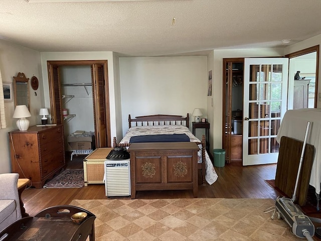 57 Harrington St, Falmouth, MA 02536 - bedroom with light wood-type flooring, a textured ceiling, and a closet