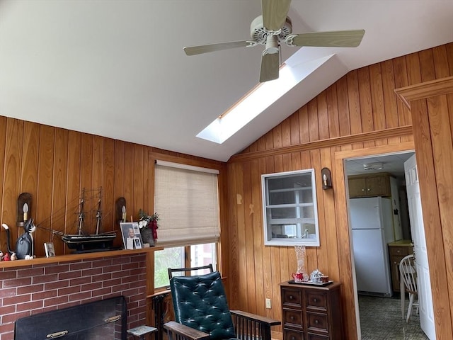 57 Harrington St, Falmouth, MA 02536 - living area with wood walls, ceiling fan, lofted ceiling, a skylight, and a brick fireplace