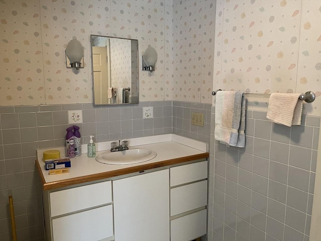 57 Harrington St, Falmouth, MA 02536 - bathroom with wallpapered walls, tile walls, a wainscoted wall, and vanity