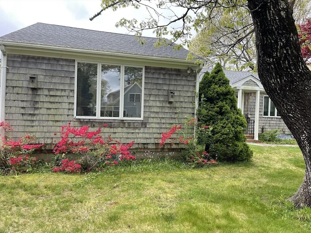 57 Harrington St, Falmouth, MA 02536 - view of property exterior featuring a shingled roof and a lawn