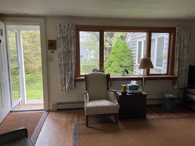 57 Harrington St, Falmouth, MA 02536 - sitting room with a baseboard radiator, plenty of natural light, wood finished floors, and baseboard heating
