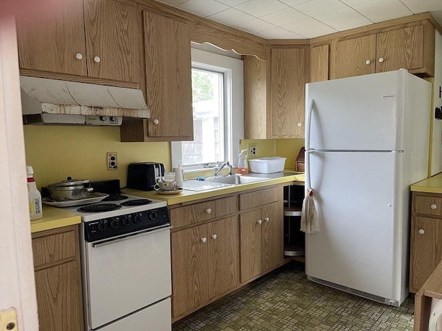 57 Harrington St, Falmouth, MA 02536 - kitchen featuring white appliances, under cabinet range hood, light countertops, a sink, and brown cabinetry