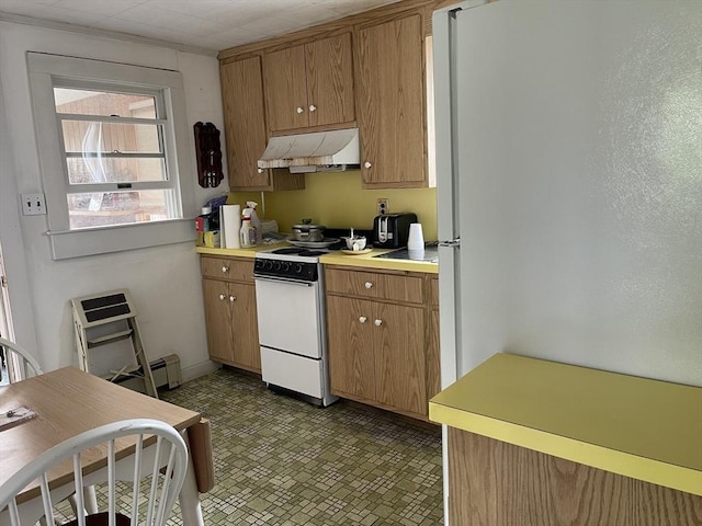 57 Harrington St, Falmouth, MA 02536 - kitchen with under cabinet range hood, white electric range oven, light countertops, and brown cabinets