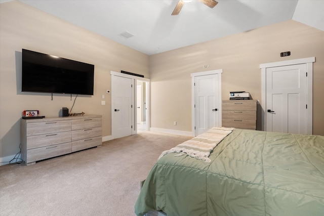 bedroom featuring light carpet, vaulted ceiling, and ceiling fan