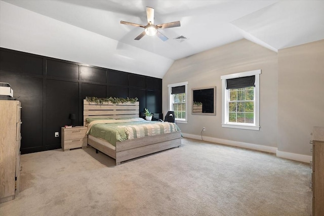 bedroom featuring baseboards, vaulted ceiling, a ceiling fan, visible vents, and light colored carpet