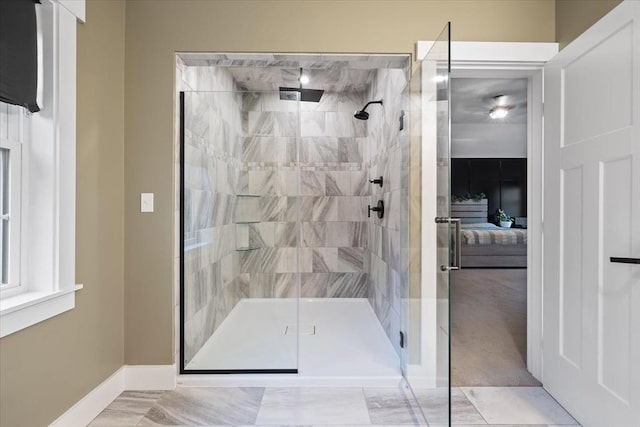 ensuite bathroom featuring baseboards, a shower stall, and ensuite bath