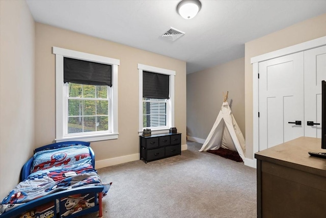 interior space with carpet flooring, baseboards, and visible vents