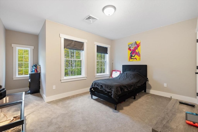 bedroom featuring visible vents, baseboards, and carpet floors