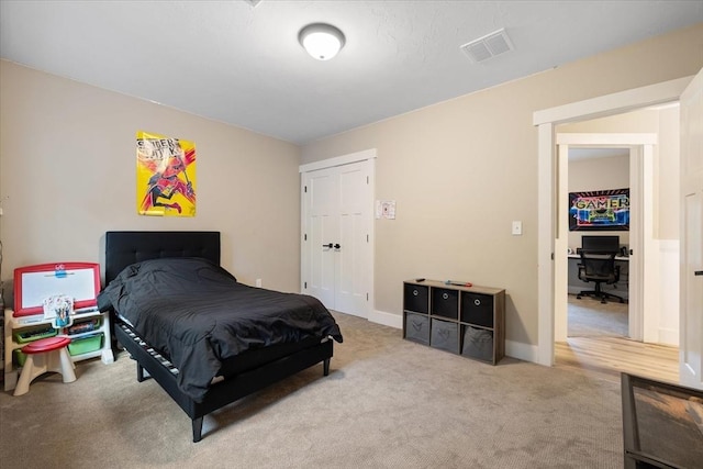 carpeted bedroom featuring baseboards and visible vents