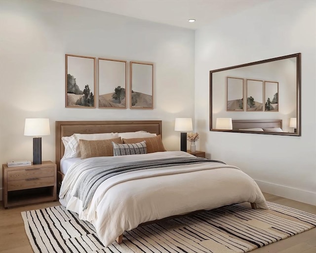 bedroom with wood finished floors and baseboards