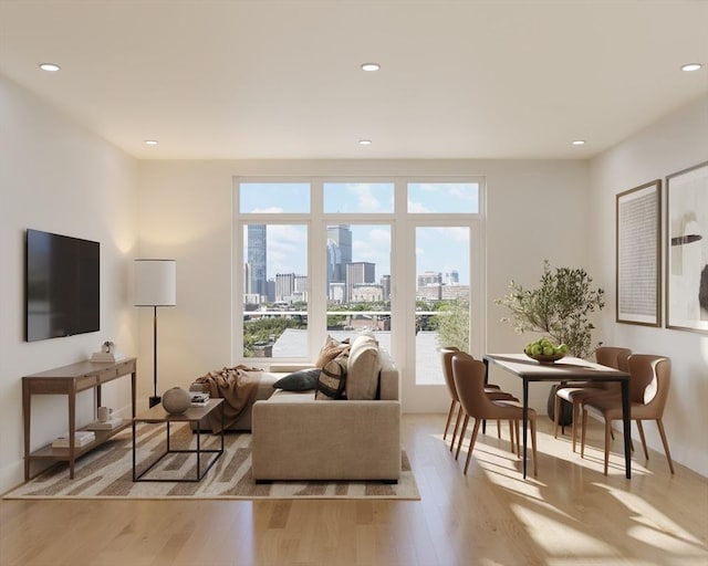 living room featuring plenty of natural light, a view of skyline, light wood-type flooring, recessed lighting, and baseboards