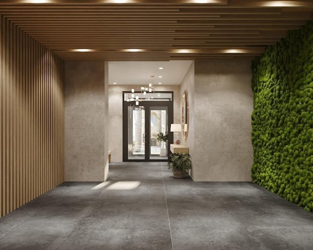property entrance with stucco siding and french doors