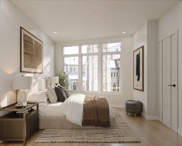 bedroom with light wood-style flooring, baseboards, and recessed lighting