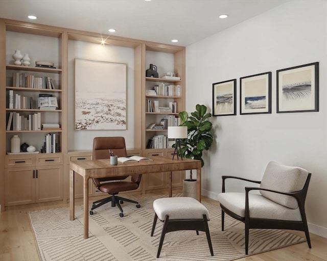 home office featuring built in features, light wood-style flooring, baseboards, and recessed lighting