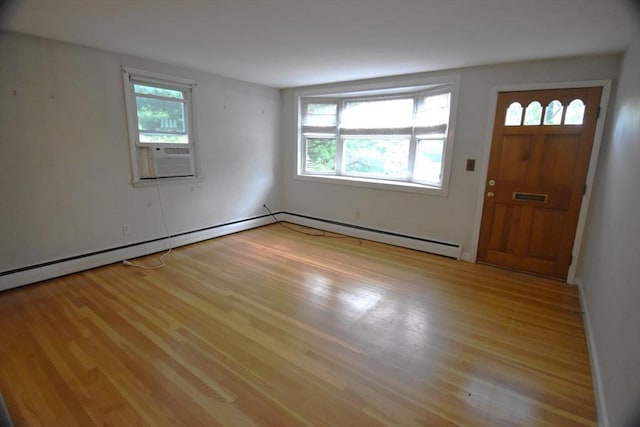 entryway with light wood-type flooring, a baseboard radiator, and baseboards