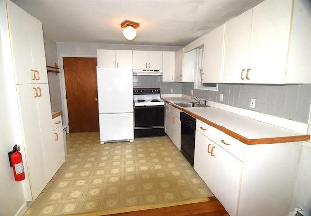 kitchen with electric range oven, freestanding refrigerator, dishwasher, light flooring, and a sink