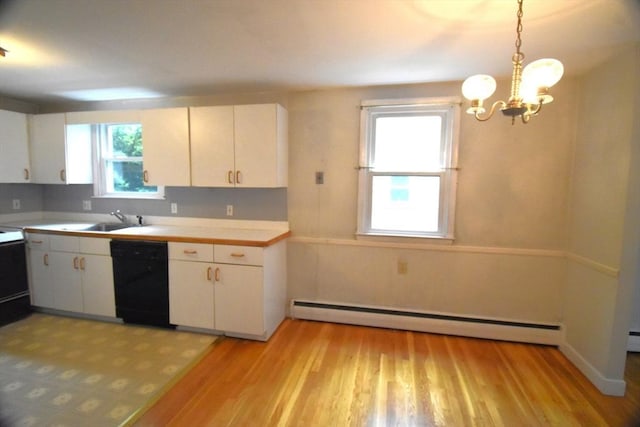 kitchen with black dishwasher, a baseboard radiator, a chandelier, and light countertops