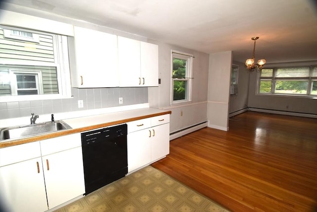kitchen featuring black dishwasher, baseboard heating, a sink, a chandelier, and healthy amount of natural light