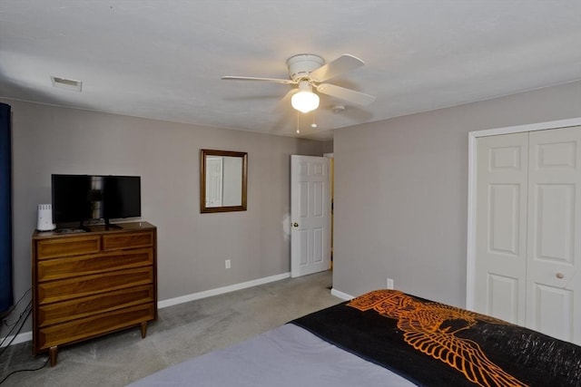 bedroom featuring ceiling fan, light colored carpet, and a closet