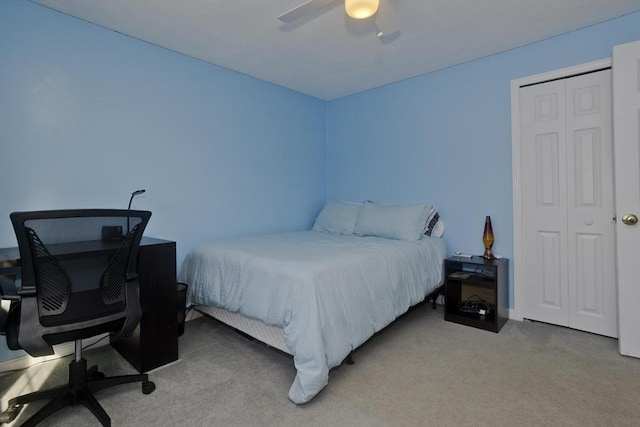 carpeted bedroom with a closet and ceiling fan