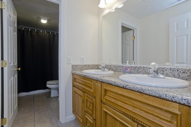 bathroom featuring vanity, toilet, and tile patterned flooring