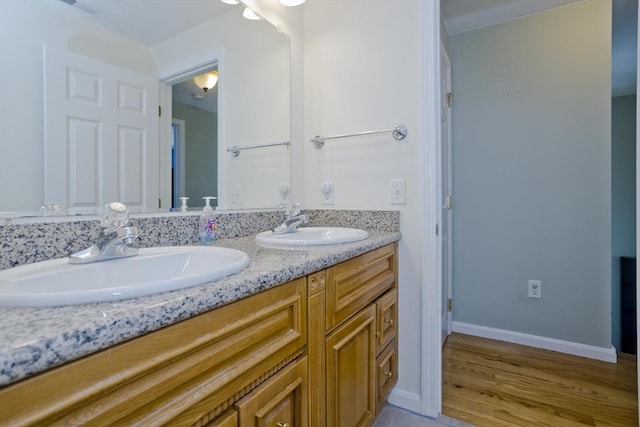 bathroom with vanity and wood-type flooring