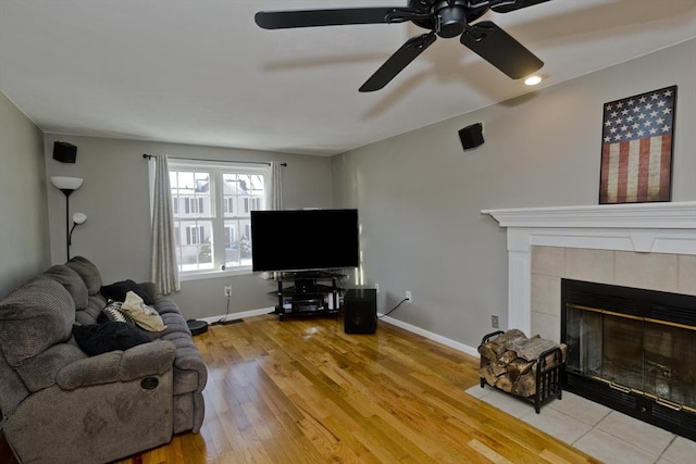 living room featuring wood-type flooring and a fireplace