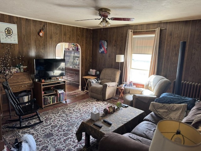 925 Washington St, Weymouth, MA 02189 - living room featuring wood finished floors, ceiling fan, a textured ceiling, wooden walls, and radiator heating unit