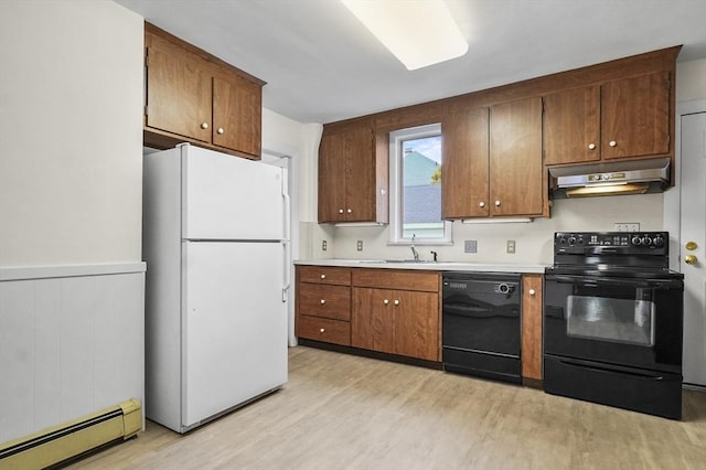 14 Lyman Ter, Waltham, MA 02452 - kitchen featuring black appliances, under cabinet range hood, baseboard heating, light wood finished floors, and light countertops
