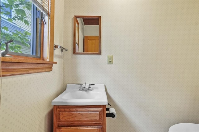 14 Lyman Ter, Waltham, MA 02452 - bathroom featuring vanity, toilet, and wallpapered walls