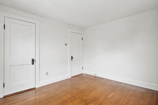 14 Lyman Ter, Waltham, MA 02452 - unfurnished bedroom featuring baseboards and wood finished floors