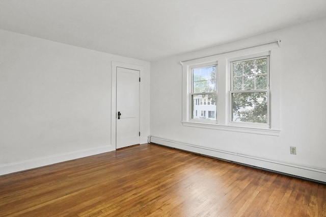 14 Lyman Ter, Waltham, MA 02452 - empty room with baseboard heating, hardwood / wood-style flooring, and baseboards
